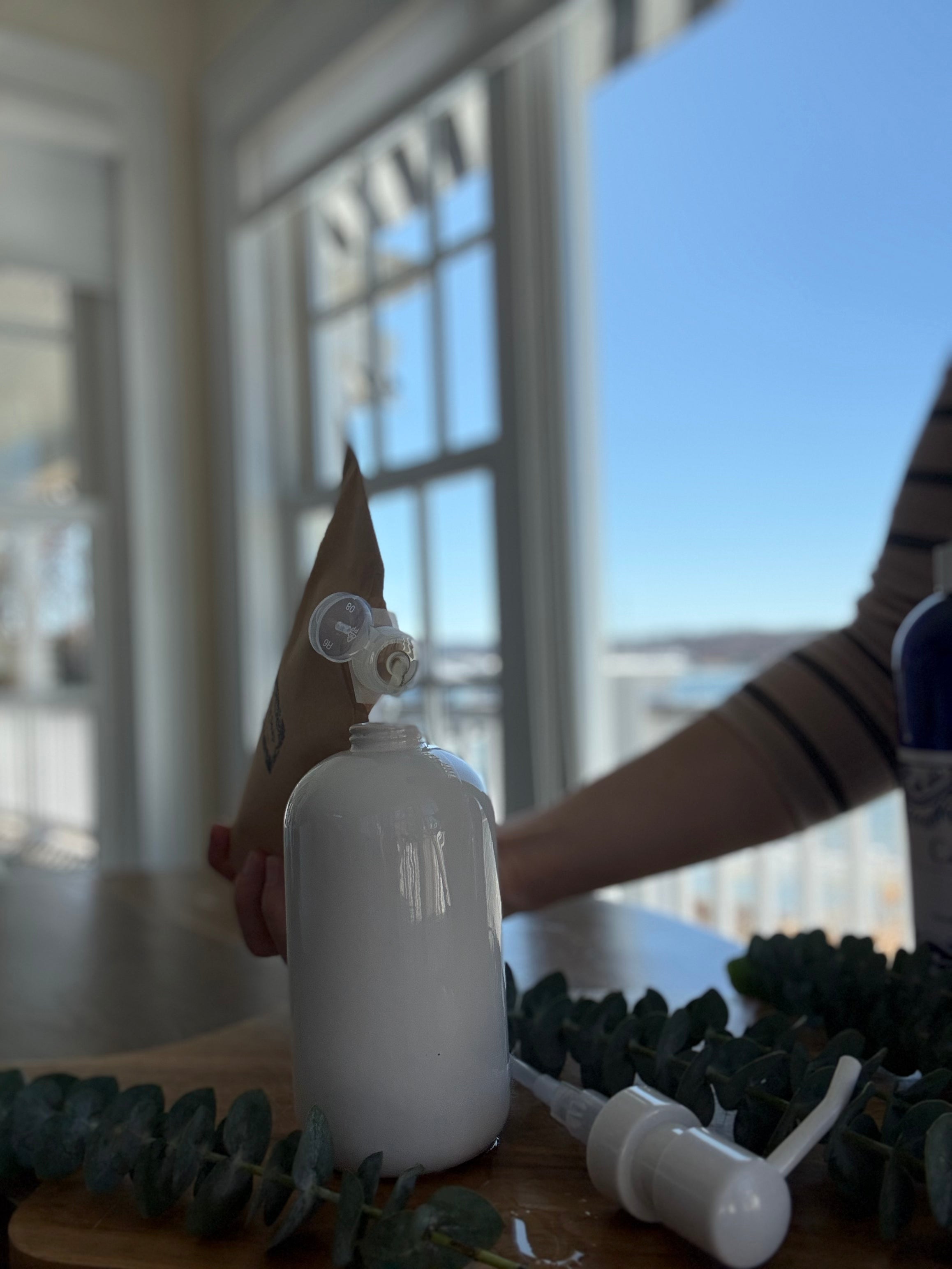 Refilling a soap dispenser with Castile soap from a large bottle